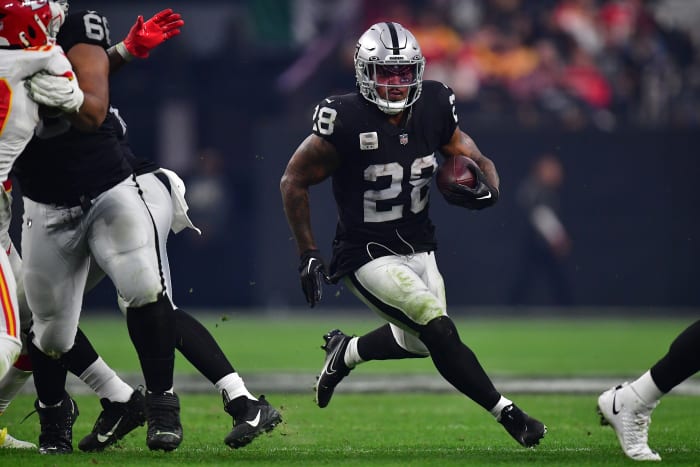 Las Vegas Raiders running back Josh Jacobs runs with the ball under his arm